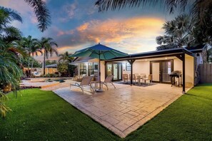 A modern house with a patio, outdoor seating, and a pool. - Tropical Getaway | Heated Pool & Patio Retreat (Fort Lauderdale)
