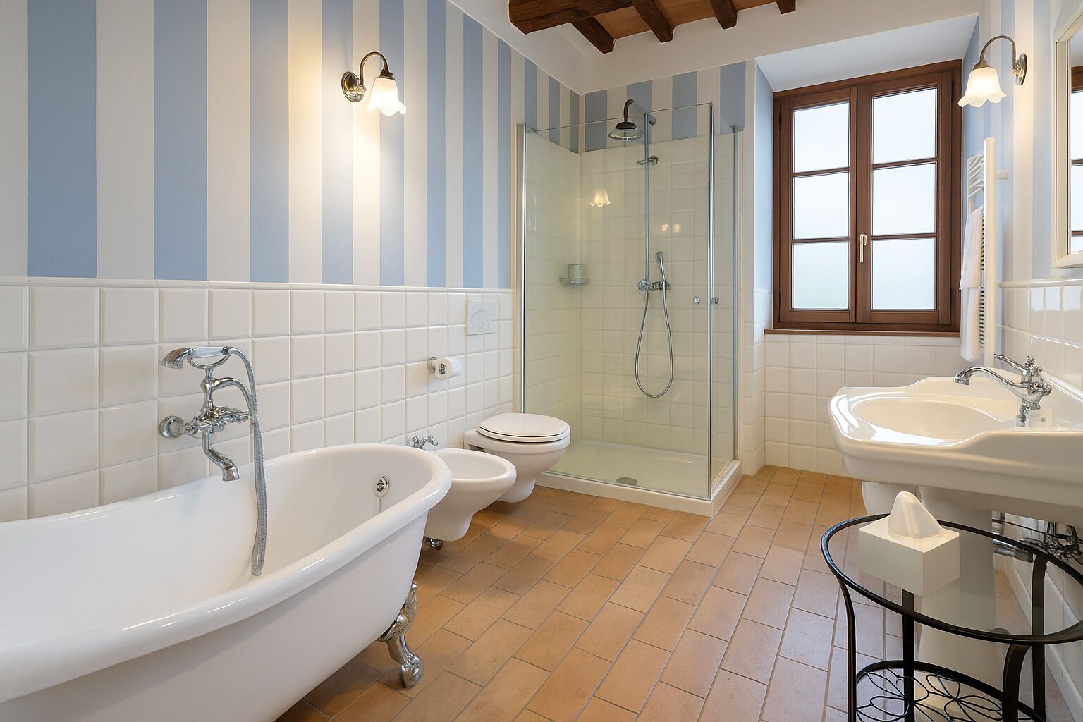 A bathroom with a freestanding bathtub, a glass-enclosed shower, a toilet, and a sink.