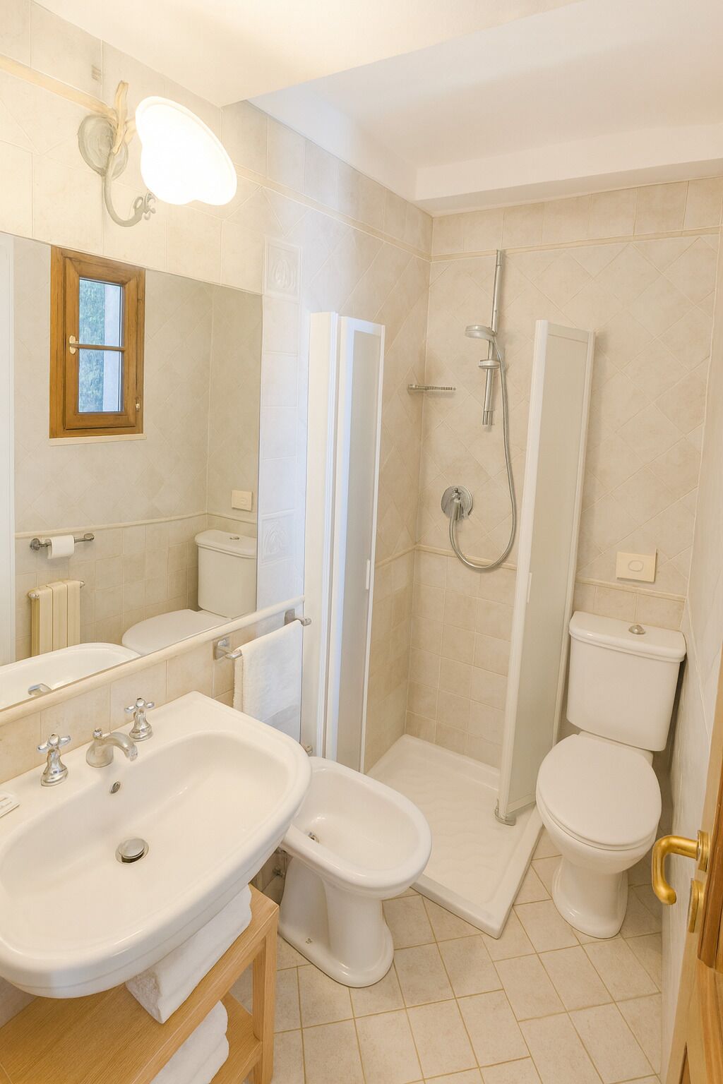 A bathroom with a sink, toilet, bidet, and shower.