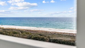 A beach view with a clear sky and ocean.