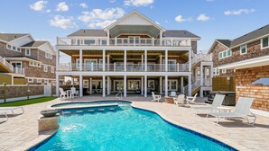 A two-story house with a swimming pool and outdoor seating. - Daniels -- Brand New Luxury Oceanfront Home (Corolla)