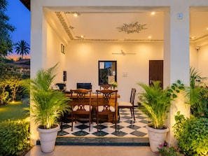 An indoor dining area with a checkered floor, wooden furniture, and potted plants. - Hill Garden Resort – Near Fateh Sagar, Udaipur (Udaipur)