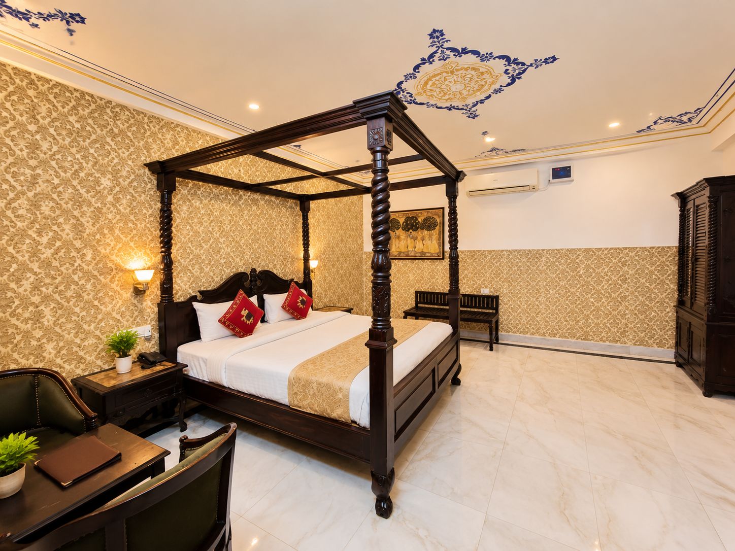A four-poster bed with a headboard, bedside tables, a desk with a chair, and a bench.