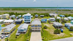 A coastal residential area with multiple two-story houses featuring balconies and waterfront views.