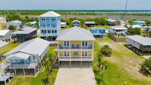 A coastal residential area with multiple two-story houses featuring balconies and waterfront views.
