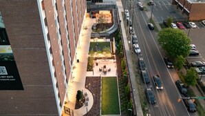 An aerial view of a hotel with a rooftop garden, a parking lot, and a street view. - The Groovy Blue Skyview (Birmingham)