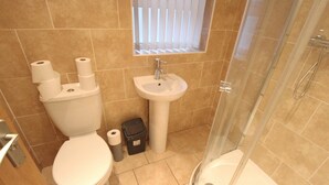 A bathroom with a toilet, sink, and shower. - Fishermans View Summa (Fleetwood)