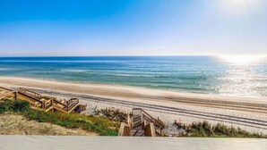 A beach with wooden walkways leading to the shore.