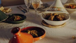 A table set for dining with various dishes, glasses, and a bottle. - The Garden of Siredrah, an Oasis with Pool and Hammam (Marrakech)