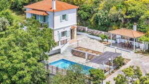 A two-story house with a swimming pool, surrounded by lush greenery. - Villa Augusta - Two Bedroom Villa, Sleeps 4 (Sporades)