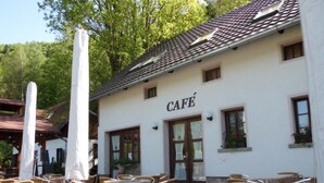 A café with outdoor seating and a white exterior. - Serene Mansion With Pool (Starkov)