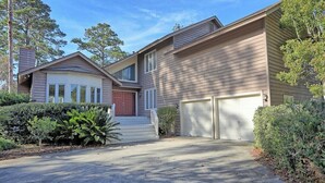 A two-story house with a garage, a front porch, and a driveway.
