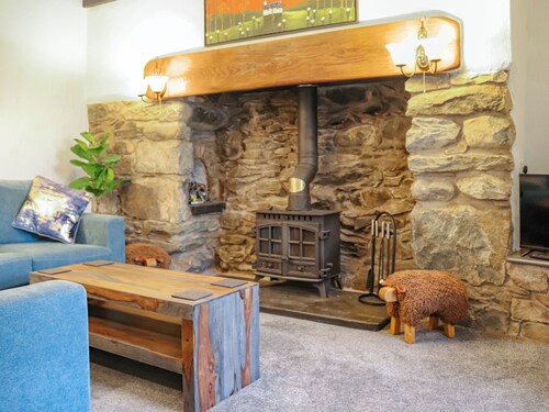 A charming cottage with distant sea views, in a peaceful setting.