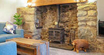 A charming cottage with distant sea views, in a peaceful setting.