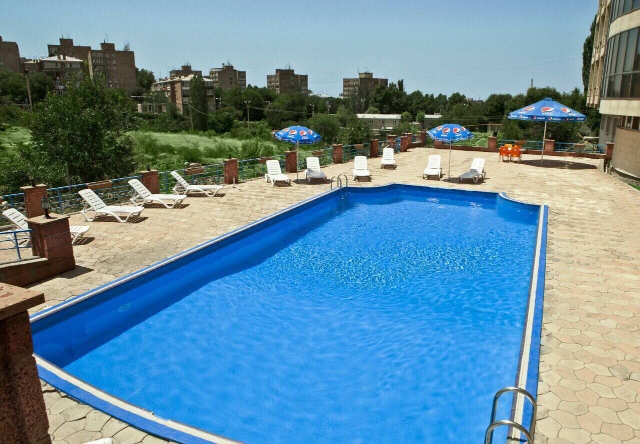 Seasonal outdoor pool, pool umbrellas, pool loungers