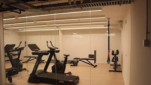 A gym with treadmills, stationary bikes, and weight machines.