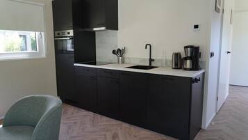 Fridge, stovetop, dishwasher, coffee/tea maker