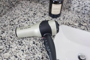 A Revlon hair dryer on a granite countertop. - Dolly's Rooftop Igloo (Nashville)