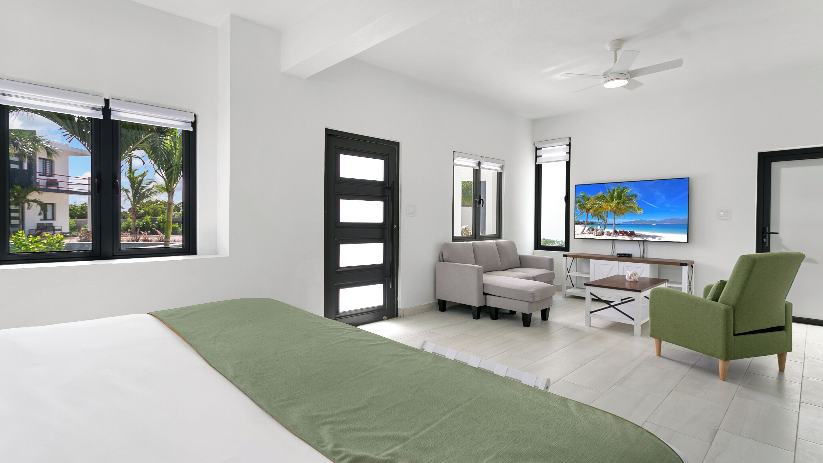 Una habitación de hotel moderna con una cama, una silla verde, un sofá, un escritorio y un televisor.