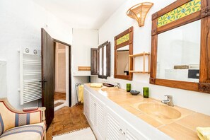 A bathroom with two sinks, a mirror, and a towel rack. - CASA AMAPOLA (Sant Josep de Sa Talaia / San Jose)