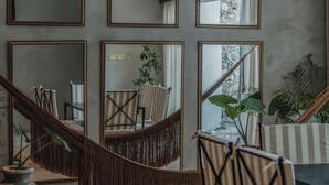 A modern interior with a staircase, mirrors, and striped chairs. - Casa Exclusiva Los Amigos, 4BDR by Cercana (Mérida)