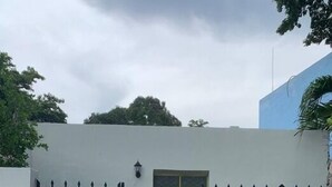 A gated entrance with a white wall, a yellow door, and a black gate. - Casita in the center of Merida. Only 5 minutes away from La Plancha Park. (Mérida)