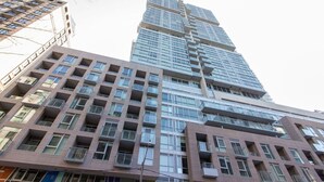 A high-rise building with multiple floors, featuring a modern architectural design with large windows and balconies.