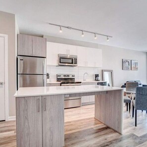 Fridge, microwave, oven, stovetop - Stylish Studio Escape near Suya Palace with Terrace (Ottawa)