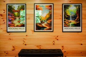 Three framed posters of Hocking Hills State Park on a wooden wall.