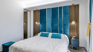 A modern bedroom with a large bed, two bedside tables, and a wardrobe. - Luxury Penthouse Seaview Whit Terrace
 Giardini Naxos/Taormina (Giardini Naxos)