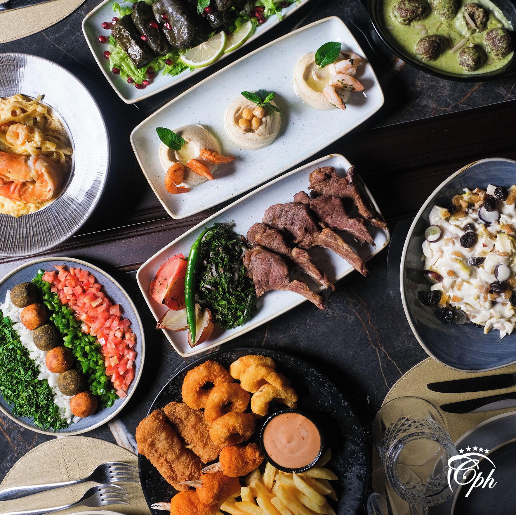 A variety of dishes including seafood, meat, and vegetarian options, arranged on multiple plates.