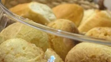 A glass container with various baked goods, possibly bread or pastries.