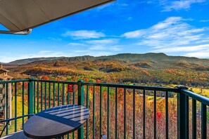 A balcony with a view of autumnal hills and a clear sky. - Sleeps 6 Mountain Views Shared Resort Amenities (Gatlinburg)