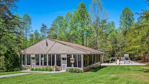 A single-story building with a gabled roof, large windows, and a covered outdoor area with a playground. - Sleeps 6 Full Kitchen Indoor Pool Mountains Views (Gatlinburg)