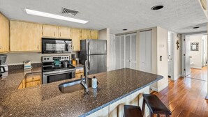 A kitchen with granite countertops, stainless steel appliances, and wooden cabinets. - Sleeps 4 Mountains Views Indoor Pool Sauna (Gatlinburg)