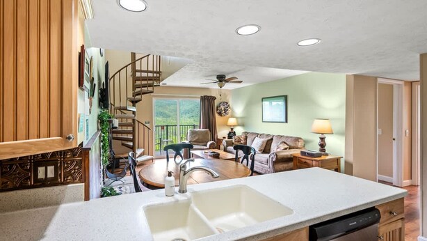 A spacious kitchen with a large island, wooden cabinetry, and a built-in dishwasher. - Sleeps 8 Pool Playground Mountain Views Hot Tub (Gatlinburg)