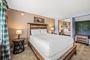 Cozy retreat with a large bed, bedside tables, and a wooden headboard.