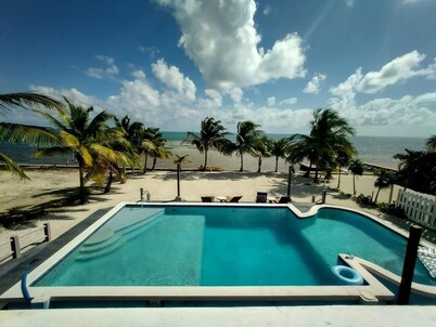 Beach front in welcoming San Pedro w/ AC, pool, fitness room, WiFi, kitchenette