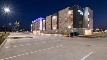 A hotel with a modern design, featuring a prominent sign for 'Everhome Suites'.