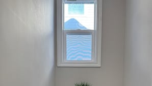 A small, white desk with a black office chair and a potted plant. - Unwind at Windemere 3-Bedroom Apartment in Thunder Bay (Thunder Bay)