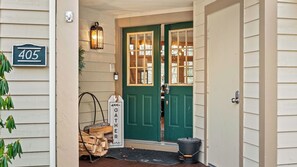 A house entrance with a green door, a mailbox, a sign reading 'GATHER HERE', and a number '405' sign. - Mountain Escape With Game Room, Balcony & Stunning Views in the Poconos Christina (Tannersville)