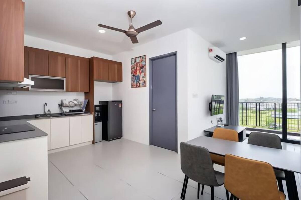 A modern kitchen with wooden cabinets, a built-in microwave, and a ceiling fan.