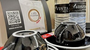 A coffee machine, two water bottles, and a QR code for brewing instructions. - I-Vista Hotel (Tawau)