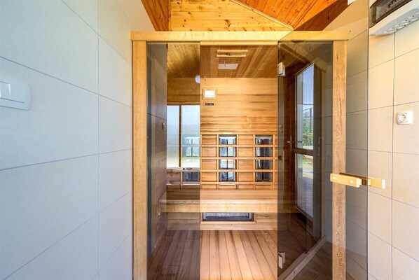 A modern interior with wooden paneling, a glass door leading to a room, and a visible window.