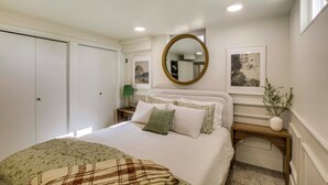 A bedroom with a bed, a bedside table, a mirror, and a window. - Scenic Patio & Views! Stay 10 Mi to Nordic Valley (Ogden)