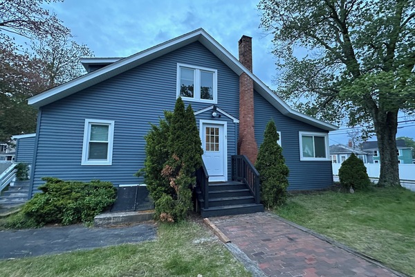 Charming blue coastal cottage with a private entrance and brick walkway. Located in a quiet, walkable neighborhood near Old Orchard Beach with free onsite parking included