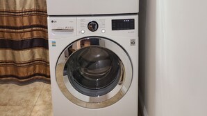 A stacked washer and dryer unit with control panels and a direct drive label. - Cozy Cottage, 2-bedroom duplex in delightful Beach City with WiFi, AC (Torrance)
