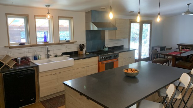 A modern kitchen with a central island, a built-in oven, and a dining area with a table and chairs. - Spacious 4 bd 2 bth Ridgway-Ouray Ranch Home; Adventure Basecamp! STR-1-2024-069 (Ridgway)