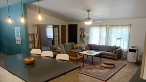 A modern living room with a central island, sofas, and a dining area. - Spacious 4 bd 2 bth Ridgway-Ouray Ranch Home; Adventure Basecamp! STR-1-2024-069 (Ridgway)