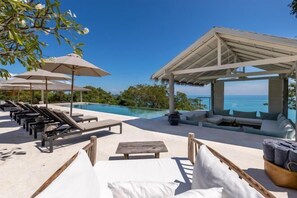 A poolside area with lounge chairs, umbrellas, and a seating area overlooking a clear blue sky and ocean. - Breathtaking Koh Koon - Provence Meets the East Sleeps 14 Adults +8 Kids (Koh Samui)